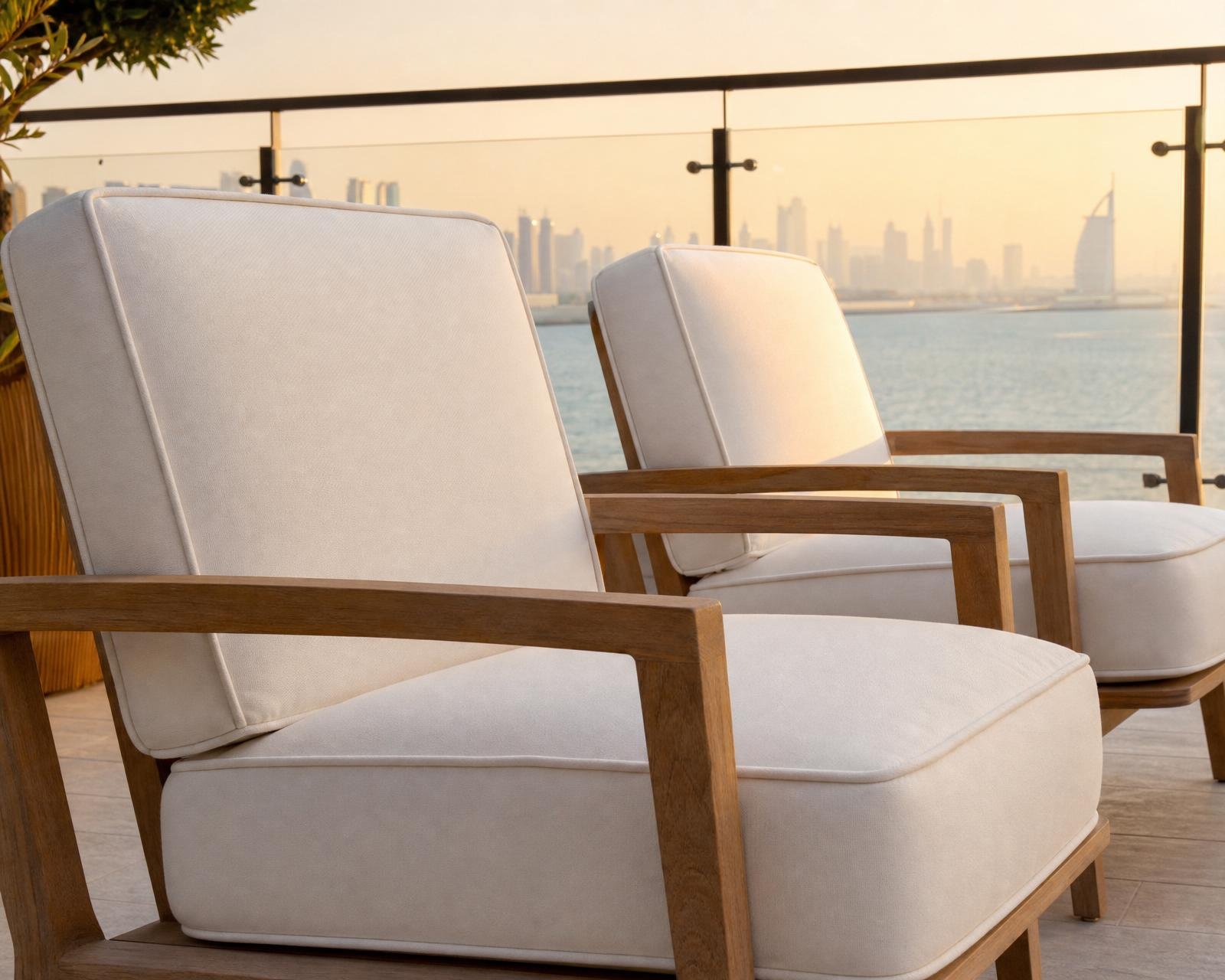 Outdoor lounge chairs upholstered in ivory performance fabric on a Dubai terrace