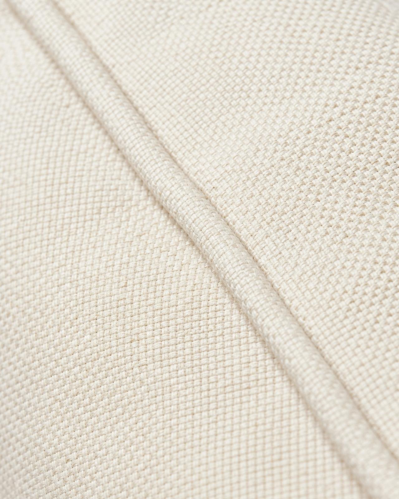 Macro of ivory outdoor upholstery fabric with weather-ready piping