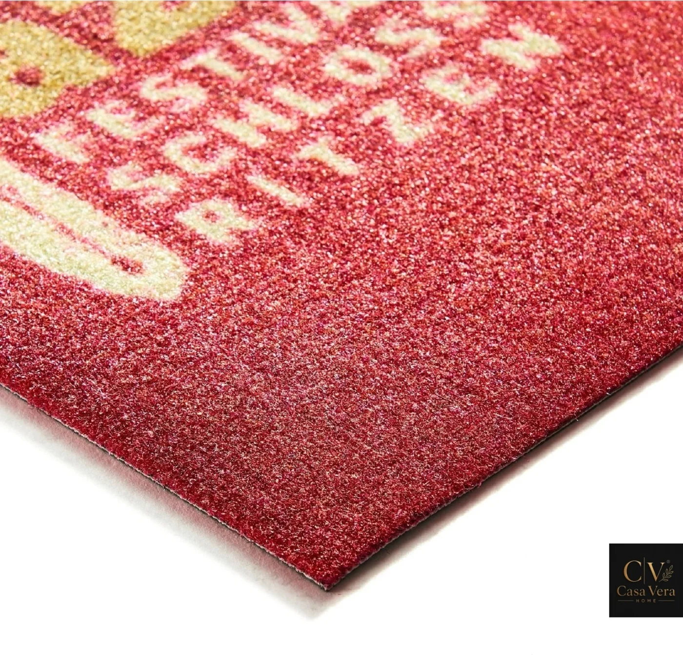 Corner detail of a red event mat with lettering printed into the fibre