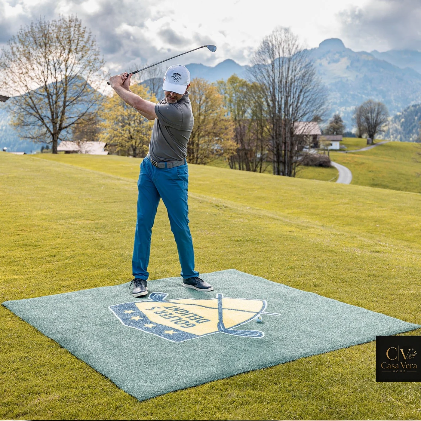 Printed outdoor mat laid on grass at an open-air golf event