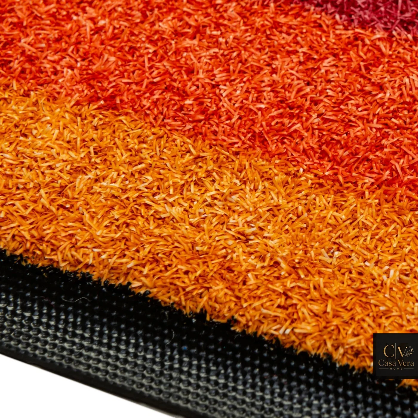 Macro view of dense orange outdoor mat fibre on its backing